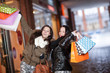 Playful shoppers with lots of purchases