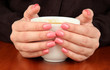 Hands holding mug of hot drink, close-up