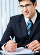 Portrait of writing smiling businessman working