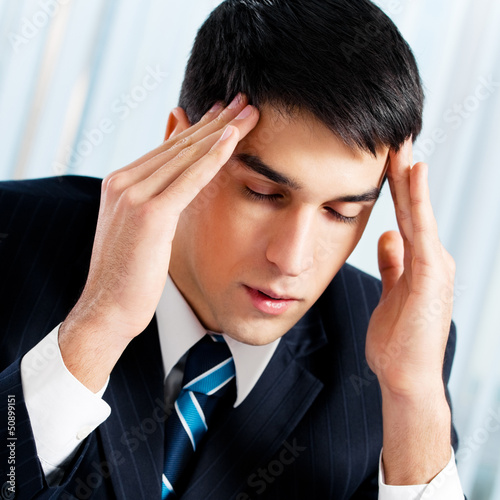 Photo: Thinking, tired or ill with headache businessman Thinking, tired or ill with headache businessman