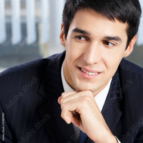 Photo: Portrait of thinkihg businessman at office Portrait of thinkihg businessman at office