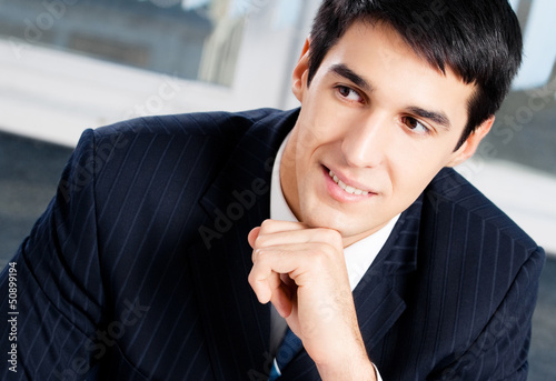 Photo: Portrait of thinkihg businessman at office Portrait of thinkihg businessman at office