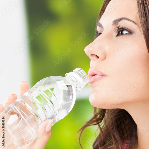 Photo: Young woman with water, outdoors Young woman with water, outdoors