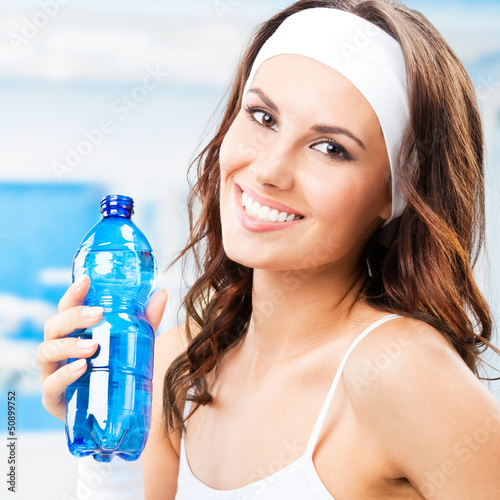 Photo: Woman with bottle of water, at fitness club Woman with bottle of water, at fitness club