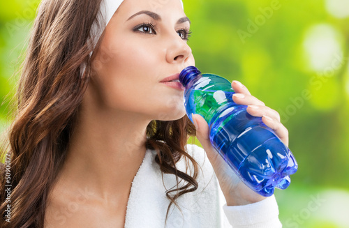 Photo: Woman drinking water, outdoors Woman drinking water, outdoors