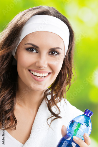 Photo: Woman with bottle of water, outdoors Woman with bottle of water, outdoors