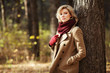 Young blond woman in autumn forest