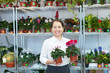 mature woman with Cyclamen plant