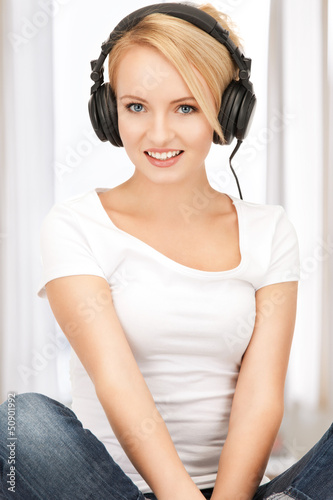 Photo: happy teenage girl in big headphones happy teenage girl in big headphones