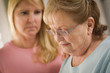 Young Woman Consoles Senior Adult Female