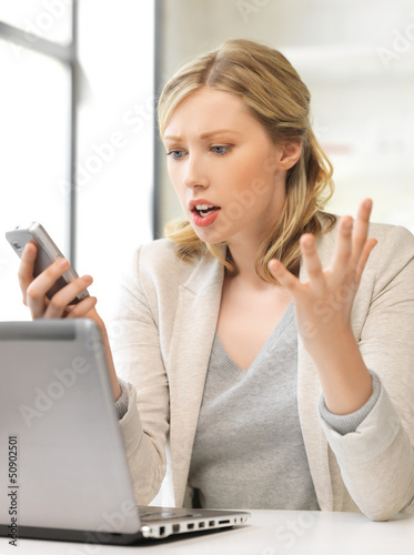 Photo: confused woman with cell phone confused woman with cell phone