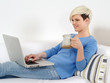 Pretty female sitting with laptop