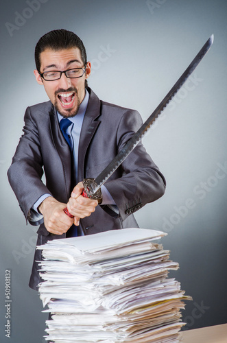 Photo: Businessman cutting the pile of paper Businessman cutting the pile of paper