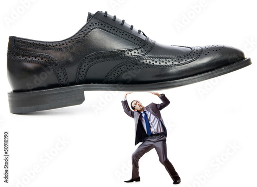 Photo: Woman domination concept with shoes and man Woman domination concept with shoes and man