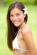Bikini girl wearing Hawaiian flower smiling fresh