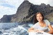 Woman on boat sailing looking at ocean