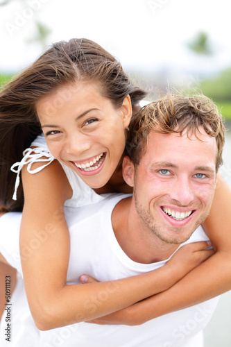 Photo: Couple happy having fun piggybacking Couple happy having fun piggybacking