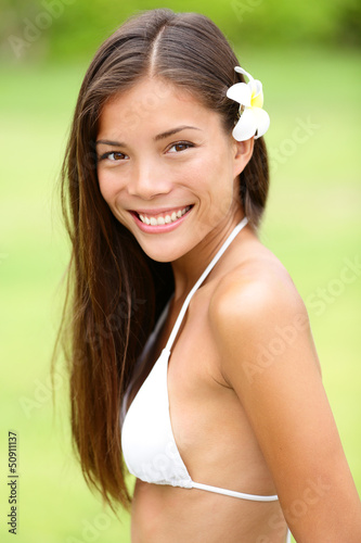 Photo: Bikini girl wearing Hawaiian flower smiling fresh Bikini girl wearing Hawaiian flower smiling fresh