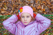 A girl looking up and swinging in hammock in autumn forest