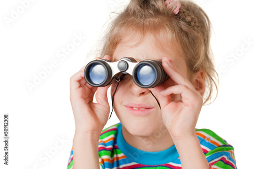 Photo: A girl looking through a small binocular isolated A girl looking through a small binocular isolated