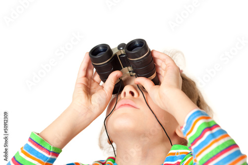 Photo: A girl looking up through a small binocular isolated A girl looking up through a small binocular isolated