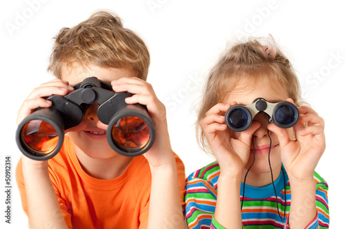 Photo: Brother and sister watching through binoculars Brother and sister watching through binoculars