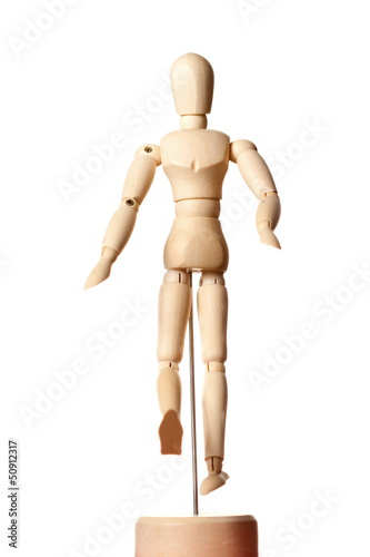 Photo: Hinged wooden mannequin on a stand on a white Hinged wooden mannequin on a stand on a white