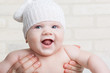 Photo: Portrait of a smiling baby in a white hat in my mother's arms Portrait of a smiling baby in a white hat in my mother's arms