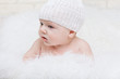 Photo: Side portrait of a concentrated baby in a white hat Side portrait of a concentrated baby in a white hat