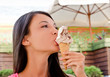 Beautiful woman eating a delicious ice cream on a hot day