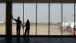 Video: silhouette of pair of lovers near the window in airport silhouette of pair of lovers near the window in airport