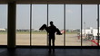silhouette of pair of lovers near the window in airport