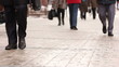 Feet of people going on the sidewalk