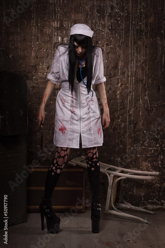 Photo: Crazy dead nurse with knife in the hand Crazy dead nurse with knife in the hand