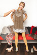 Photo: hand holding shirt in front of woman hand holding shirt in front of woman