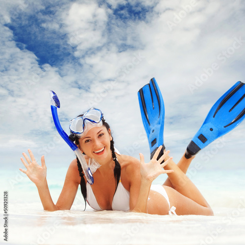 Photo: Happy woman with snorkeling equipment on the beach Happy woman with snorkeling equipment on the beach