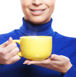 Young woman in a blue sweater with the cup of tea