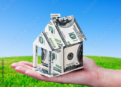 Photo: House made of money in hand House made of money in hand