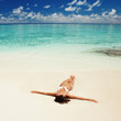 Cute woman relaxing on the tropical beach