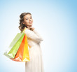 Beautiful young woman with the bright shopping bags