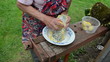 senior woman hands shredder potato with metal grater table