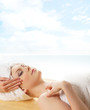 Young beautiful lady getting spa treatment isolated on white