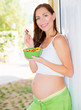 Expectant young lady eat salad