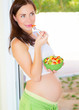 Expectant girl eat vegetables