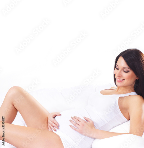 Photo: Young attractive pregnant woman with the beautiful belly over wh Young attractive pregnant woman with the beautiful belly over wh