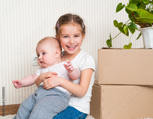 Photo: Little girl moving into new house Little girl moving into new house
