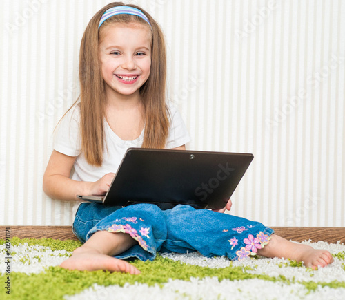 Photo: little girl with a laptop little girl with a laptop