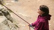 Women belaying a rock climber