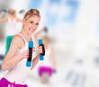 Photo: Young pretty woman holding weights and doing body training Young pretty woman holding weights and doing body training