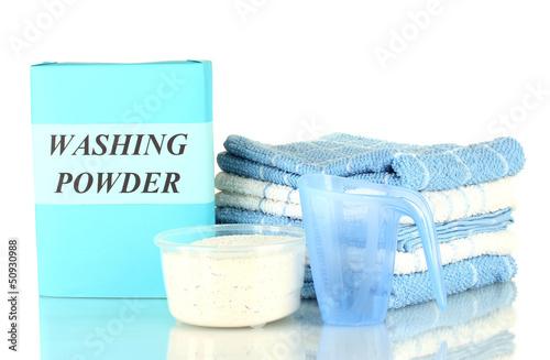 Photo: Box of washing powder with blue measuring cup and towels, Box of washing powder with blue measuring cup and towels,